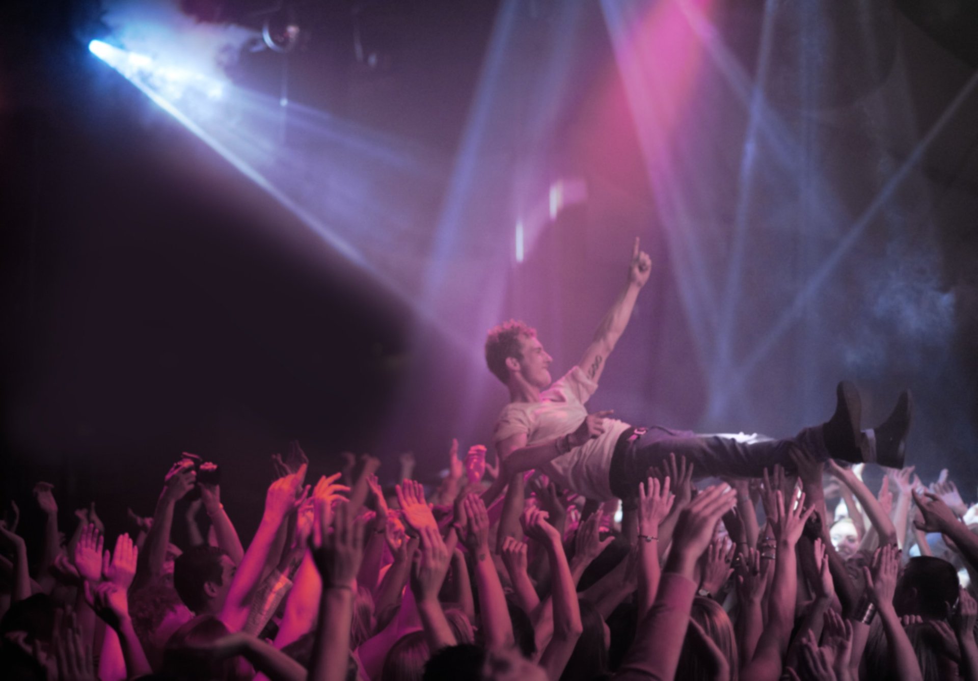 A stage diver being carried across the audience at a rock concert